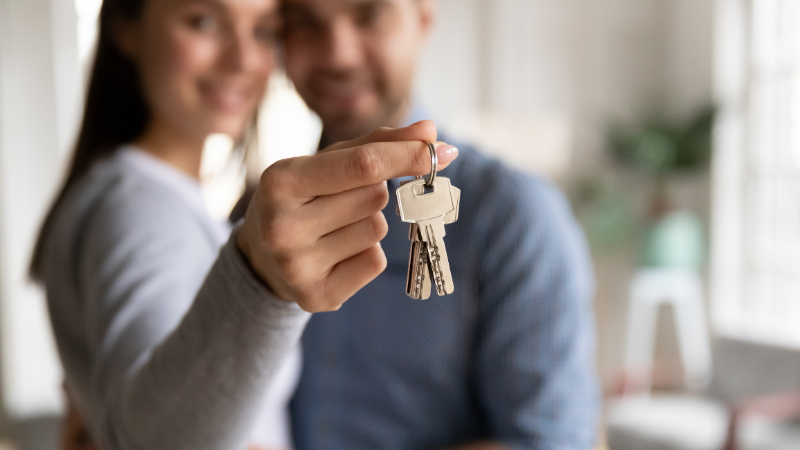 couple holding the keys for their new house